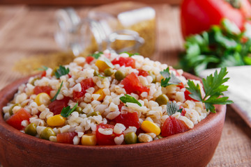 cooked bulgur with tomato corn and green peas