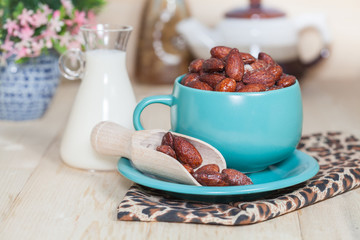 Almonds caramel with milk on table. Selective focus, shallow DOF
