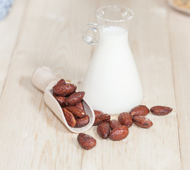 Almonds caramel with milk on table. Selective focus, shallow DOF