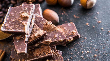 Chocolate and nuts on a black table