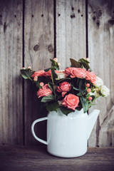 Bouquet of roses in vintage coffee pot