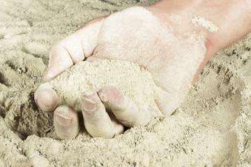 Man hand with a handful of sand