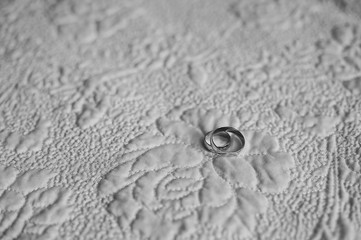 Two engagement wedding rings on textile background