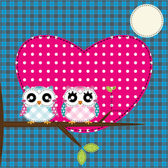 Two cute owls on the tree
