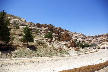The long, hot road in the ancient city of Petra. Jordan. The road runs between the rocks and through narrow gorges. Ancient caves like home. The remains of an ancient aqueduct. Spring 2010.
