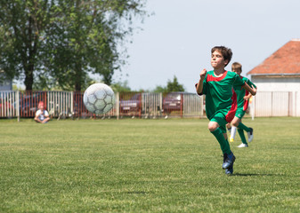 boys kicking football on the sports field