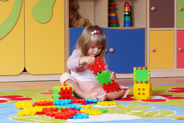 Two-year girl playing and learning in preschool