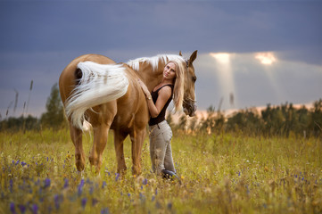 Woman and golden horse at sunset