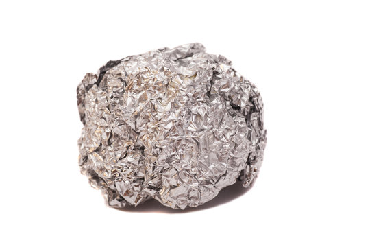 crumpled ball of aluminum foil on white