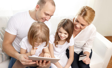 happy family with tablet pc and credit card