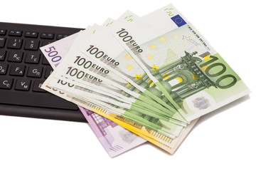 Euro banknotes on keyboard