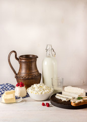 Dairy products on white wooden table.