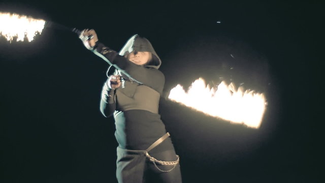Close up of fire juggler baton twirling 