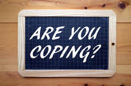 The question Are You Coping? in white text on a slate blackboard