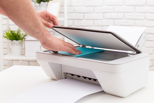 Man's hand working with printer