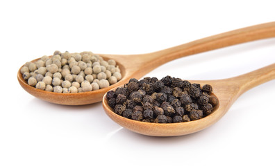peppercorn in the wooden spoon on white background