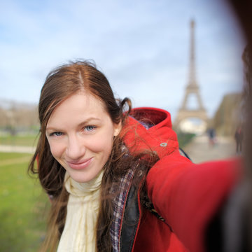 Woman taking selfie near the Eiffel tower