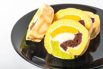 Yam roll cake on black plate