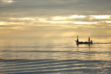 fisher man and boat in the sea Hua Hin Thailand