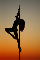 Silhouette of a girl on the pylon 
