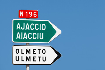 Road sign. White and green arrows with destination