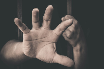 A hand sticking out of a detention attempt.