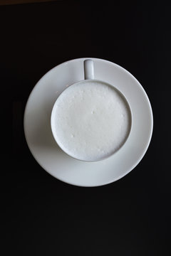 Hot milk cup on black table