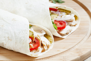 Shawarma, turkish doner kebab, roll with meat and pita bread on