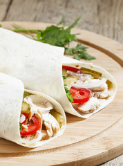 Shawarma, turkish doner kebab, roll with meat and pita bread on