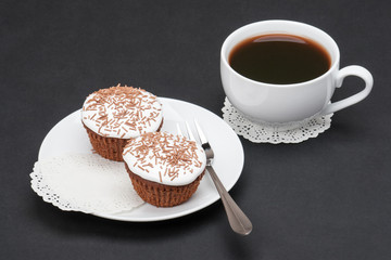 Cupcakes With Cocoa White Cream And Sprinkles. Cup Of Coffee
