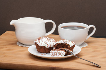 Cupcakes With Cocoa White Cream And Sprinkles. Coffee And Milk