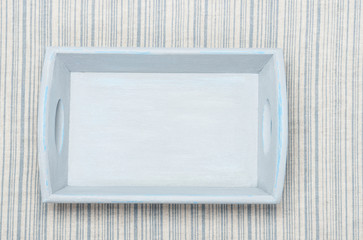 Old Painted Wooden Tray On Natural Linen Striped Textile