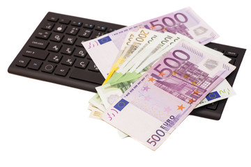 Euro banknotes on keyboard
