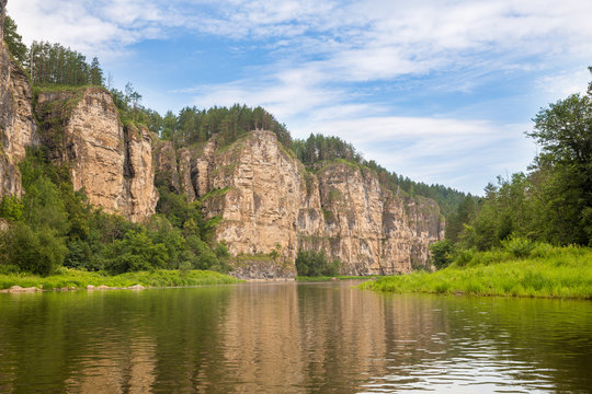 Tourist route to the Urals. Big prites and  entrance to the cave at an altitude of 60 meters view from the river