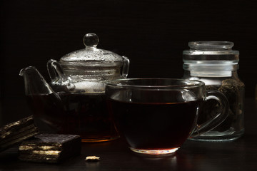 Cup with tea and teapot