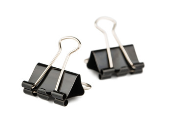 Two metal paper binder clips
