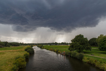 Winsen (Aller), Germany - July 29, 2015: Photograph of the river Aller and an approaching summer...