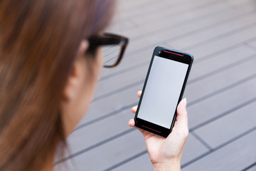 Woman hold a cellphone with blank screen
