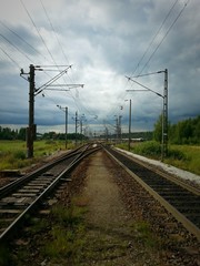 Railway shunting yard. Rail tracks and switches on cloudy summer day.