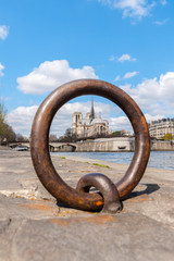 Fototapeta premium blurred view of Notre Dame trough Ring for anchoring boats along the Seine river