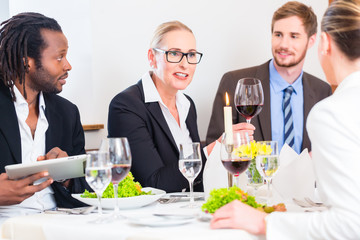 Team at business lunch meeting in restaurant