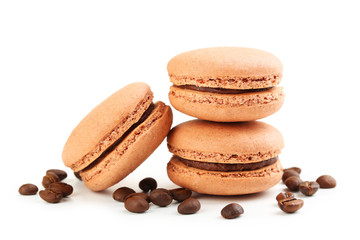 Tasty coffee macarons with coffee beans isolated on white
