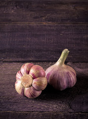 Garlic on dark wooden background.