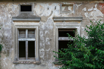 Fototapeta na wymiar Old windows in ruined wall of an old manor house in Poland.