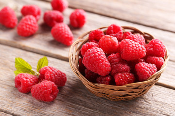 Red raspberries on grey wooden background