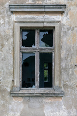 Old window of a ruined wall of an old manor house in a small village in Poland.