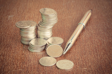 Pen and coins with filter effect retro vintage style