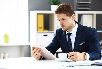 Businessman using his tablet in office