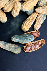 heap of moldy peanuts on a black background