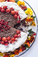 Cream cake with flower and berries